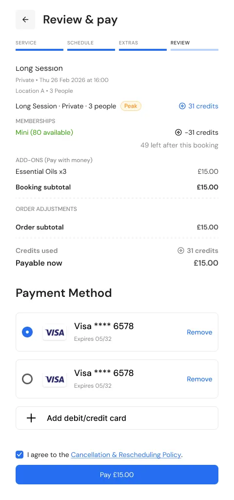 Order summary with 31 membership credits used and £15 payable for the add-ons, above the saved Visa cards